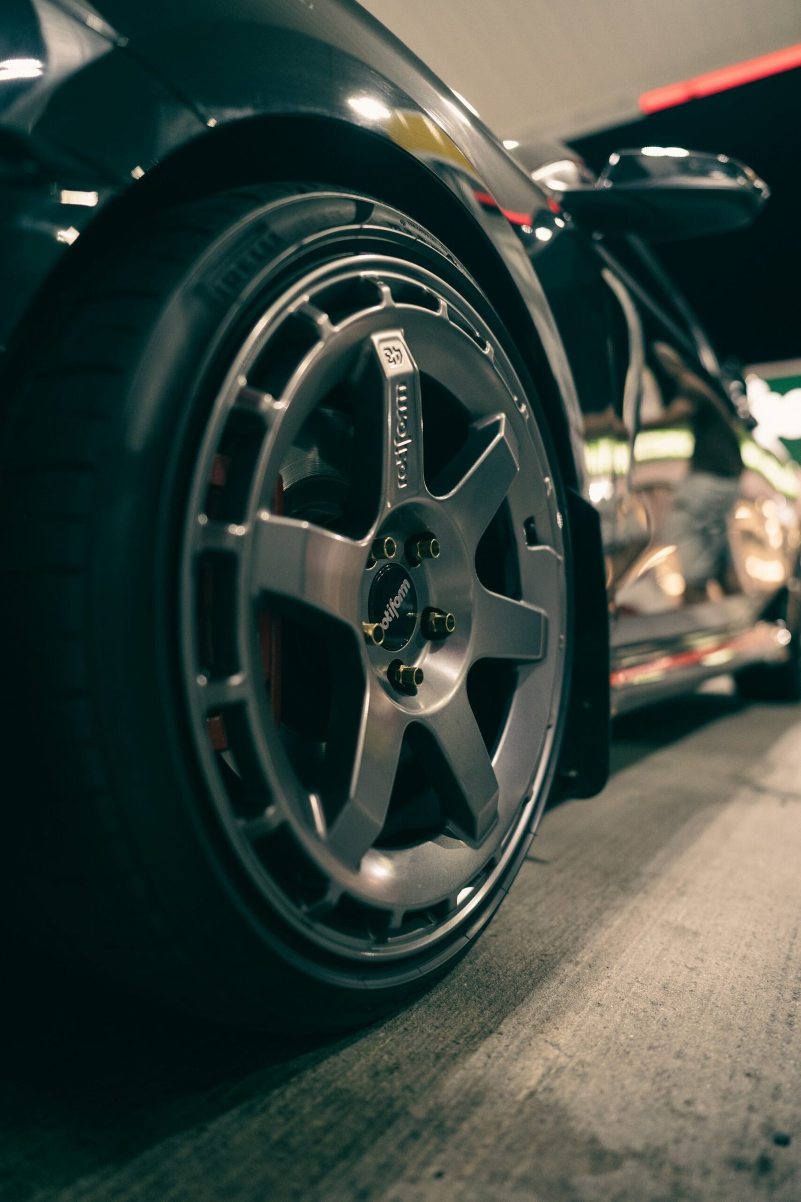 Close-up of a black car wheel on the road