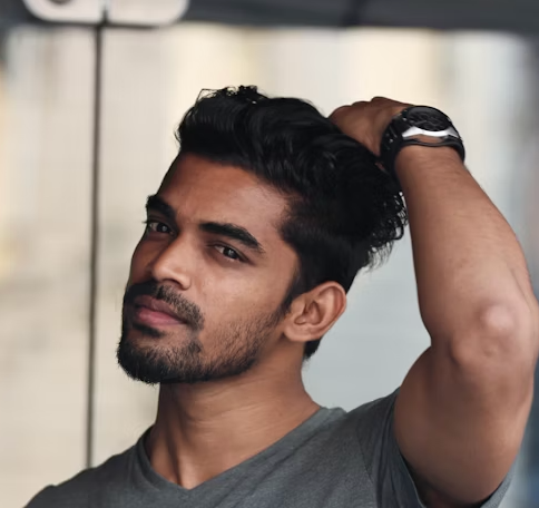 Man touching his head, looking thoughtful